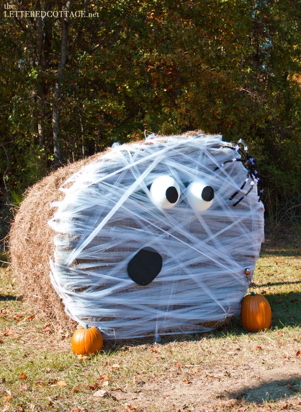 a hay bale shaped like a monster with googly eyes