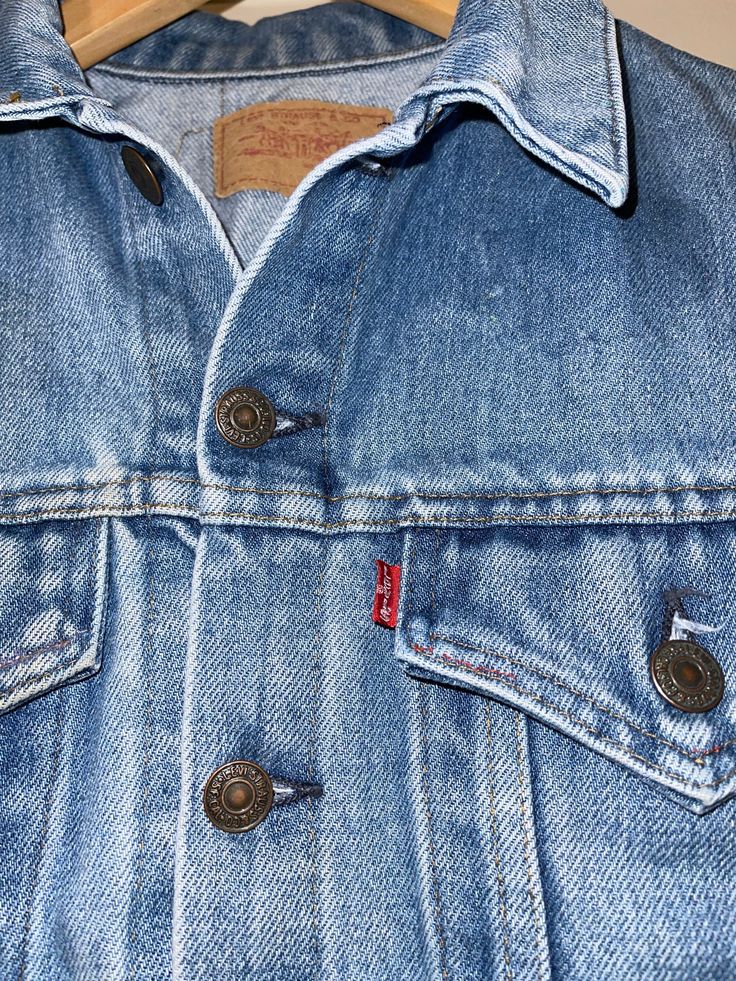 This preowned condition jean jacket is super cute with the perfect faded blue color. I can't make out tag size. Measurements point to a small or medium. Slightly fitted. Made in the USA. Appears to have had patches ironed on the chest and back but they were removed at some point. 90s Levis, Levis Denim Jacket, Towels Kids, Womens Jackets, Weird Shirts, Brown Leather Sandals, Feb 13, Levis Denim, Pocket Tshirt