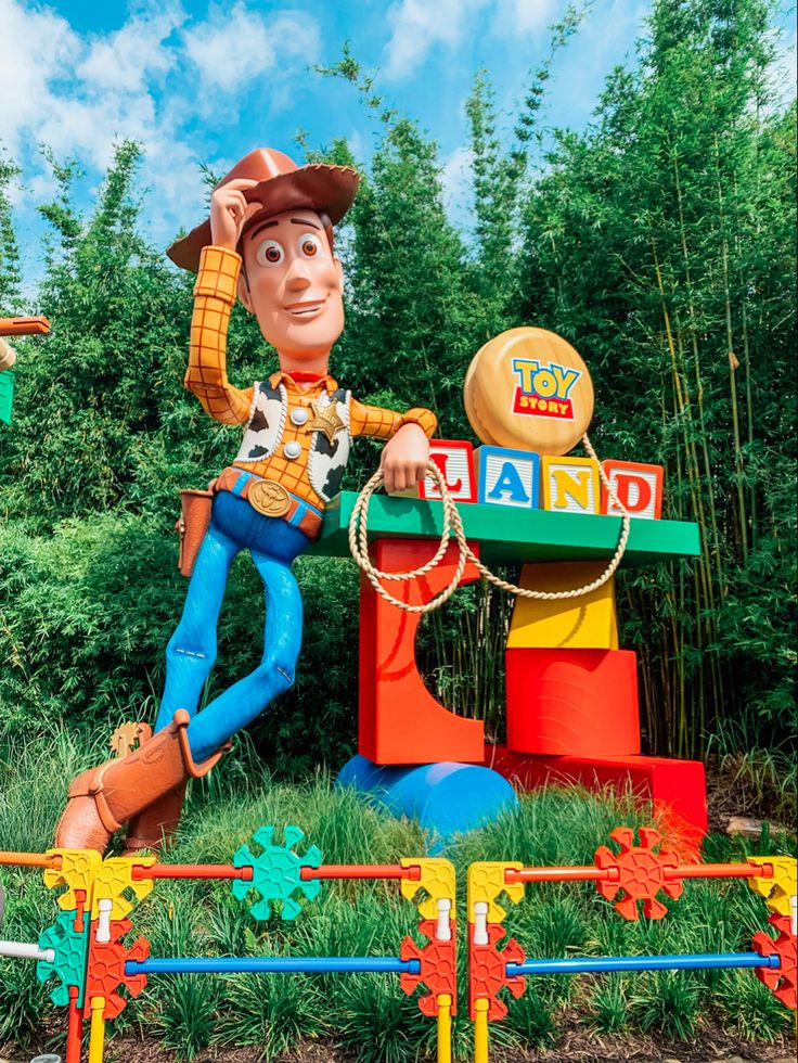 a toy story land sign with woody on it