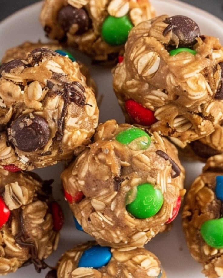 several cookies with m & m candies and chocolate chips on top are arranged in the shape of an oatmeal ball