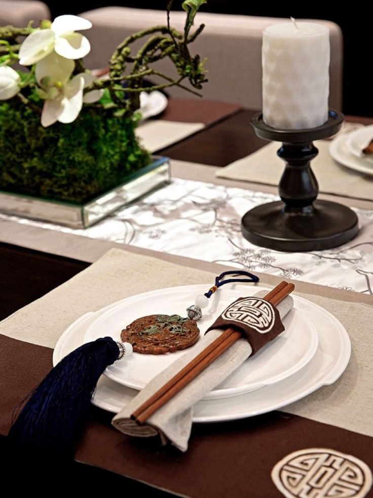 the table is set with white plates and silverware