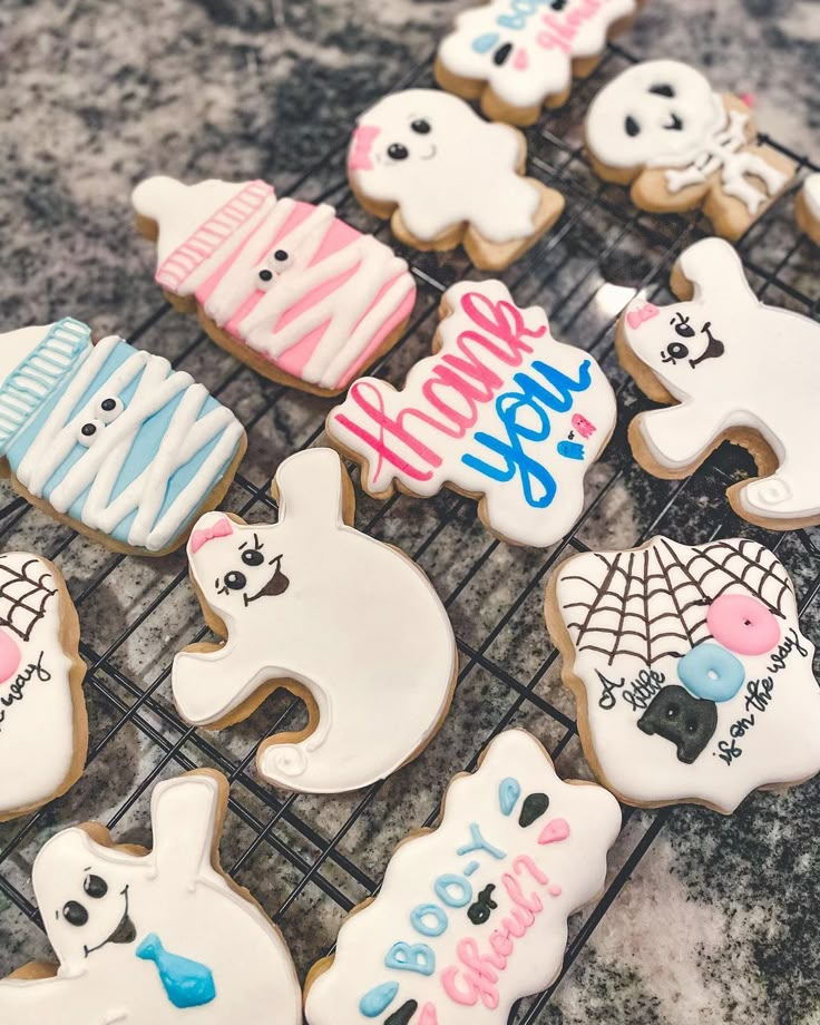 some decorated cookies are sitting on a cooling rack