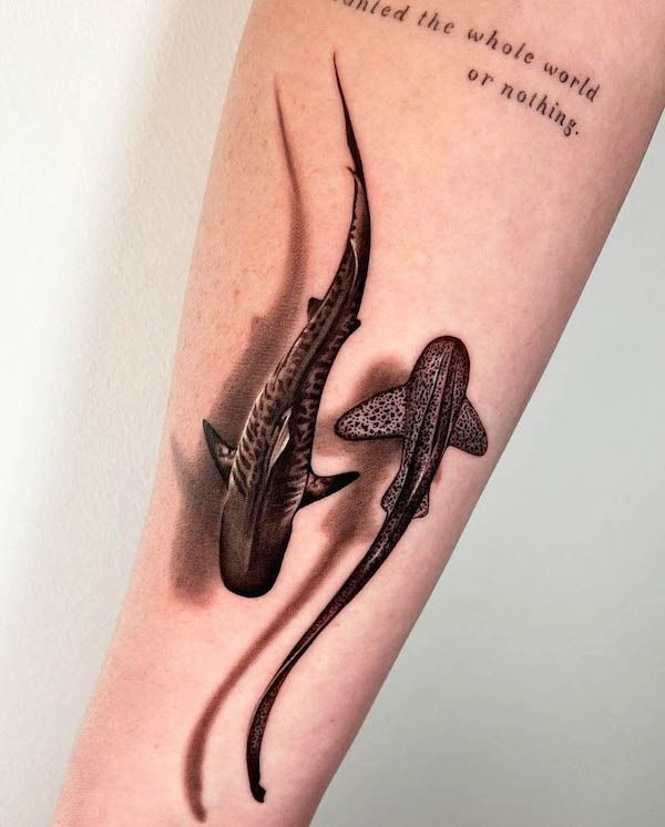 an arm with two lizards on it and the words, i believe that one world or nothing