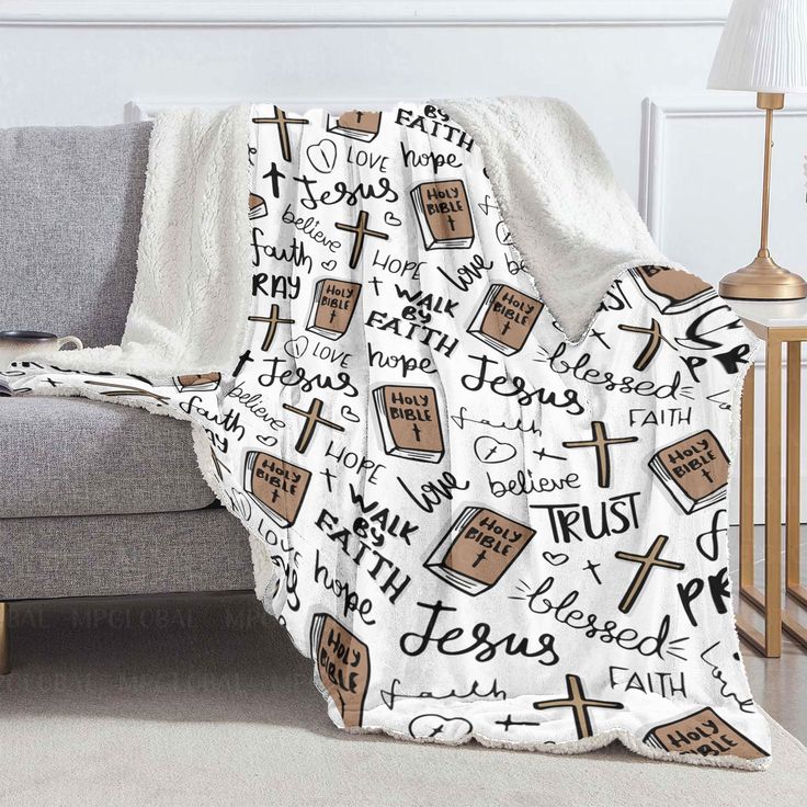 a blanket with the words jesus and bibles on it is sitting in front of a couch