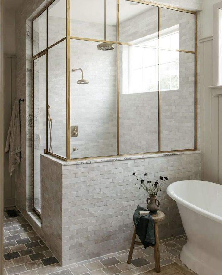 a bath room with a tub a sink and a mirror on the wall next to a window