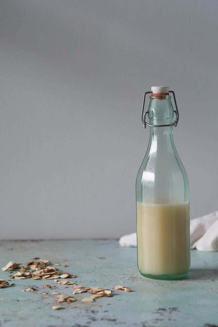 a glass bottle filled with milk sitting on top of a table