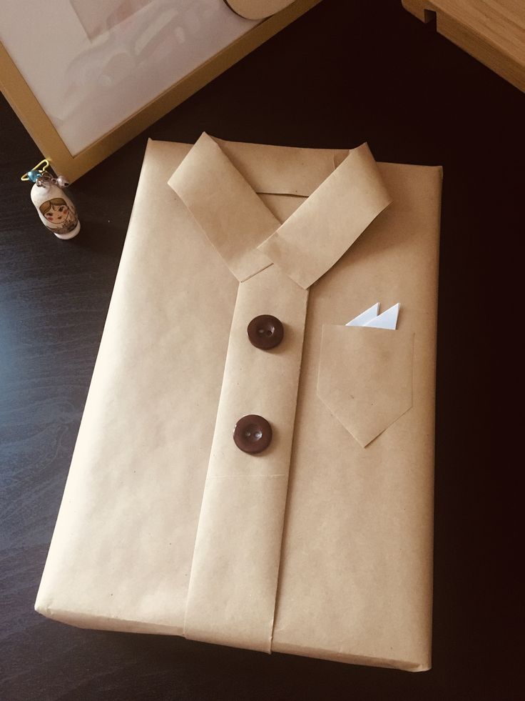 a paper bag with a shirt and buttons on it