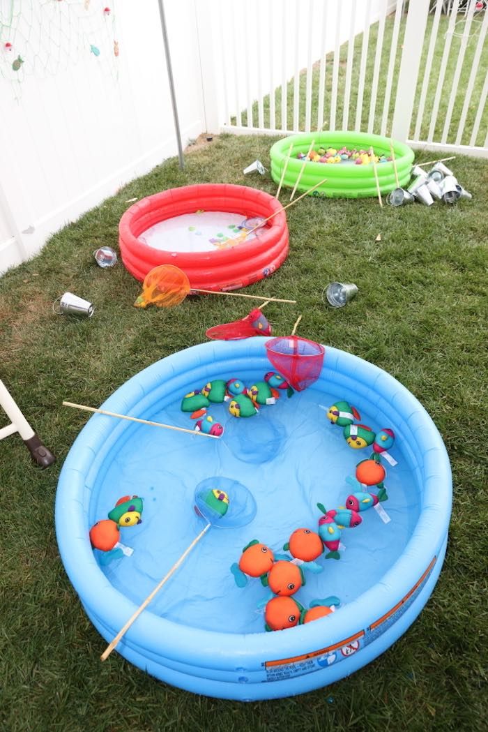 an inflatable pool with toys on the grass