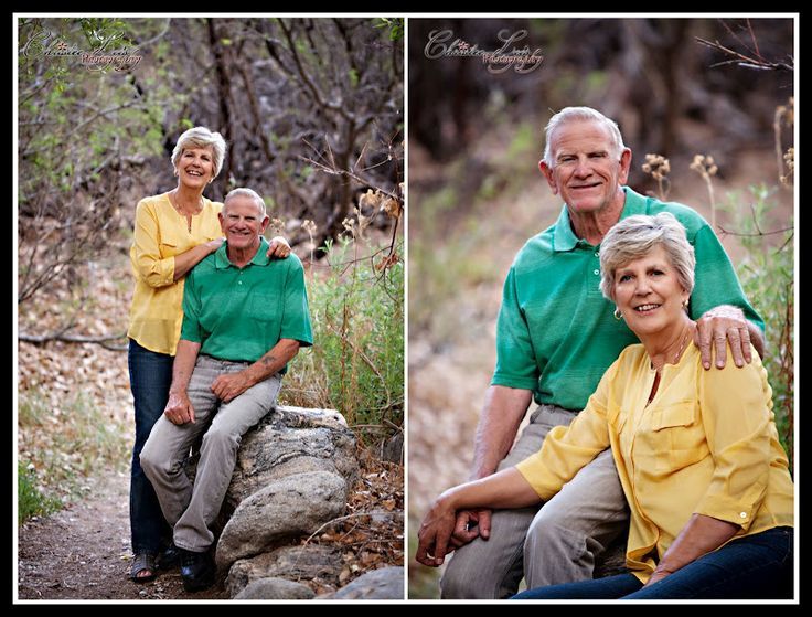 an older couple sitting on top of a rock in the middle of some brush and trees