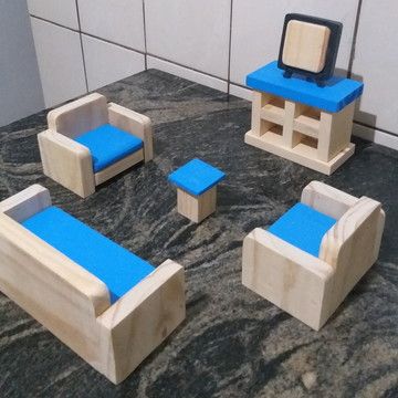 wooden furniture made to look like an old tv set with blue seats and footstools