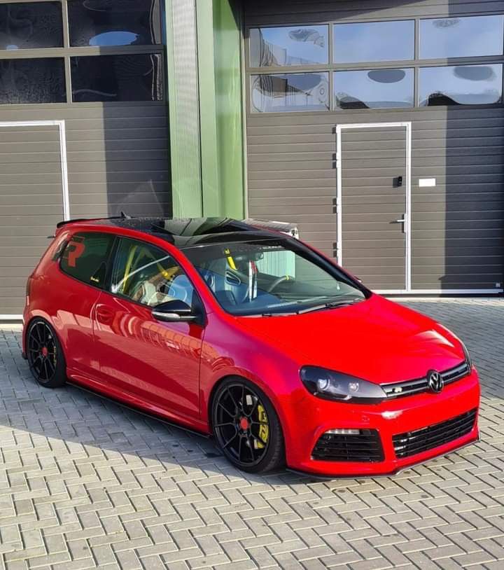 a red car parked in front of a building