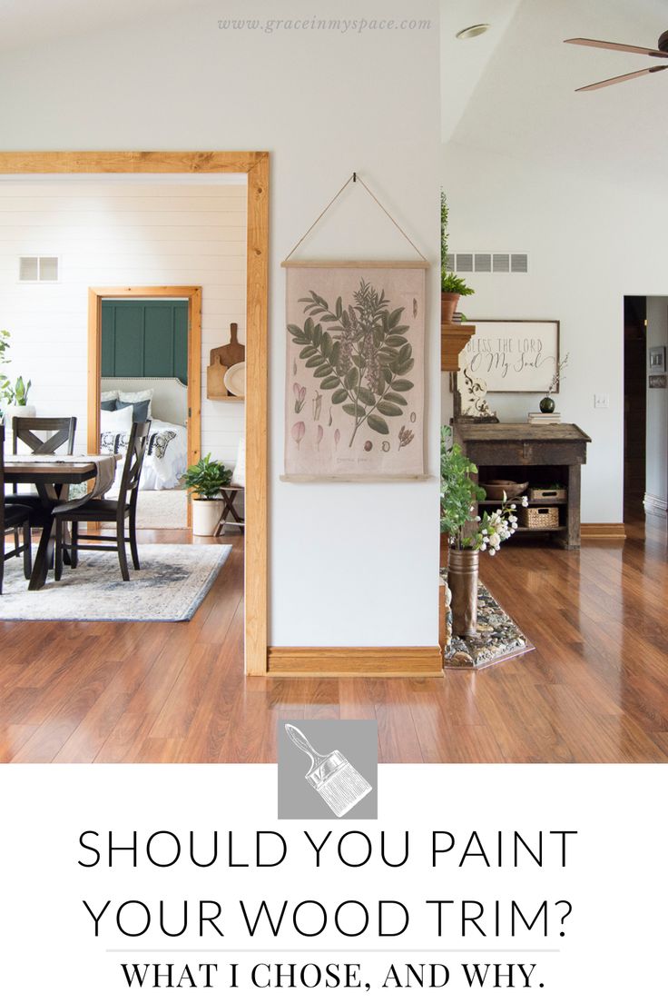 a living room with hardwood floors and white walls, the words should you paint your wood trim? what i chose, and why