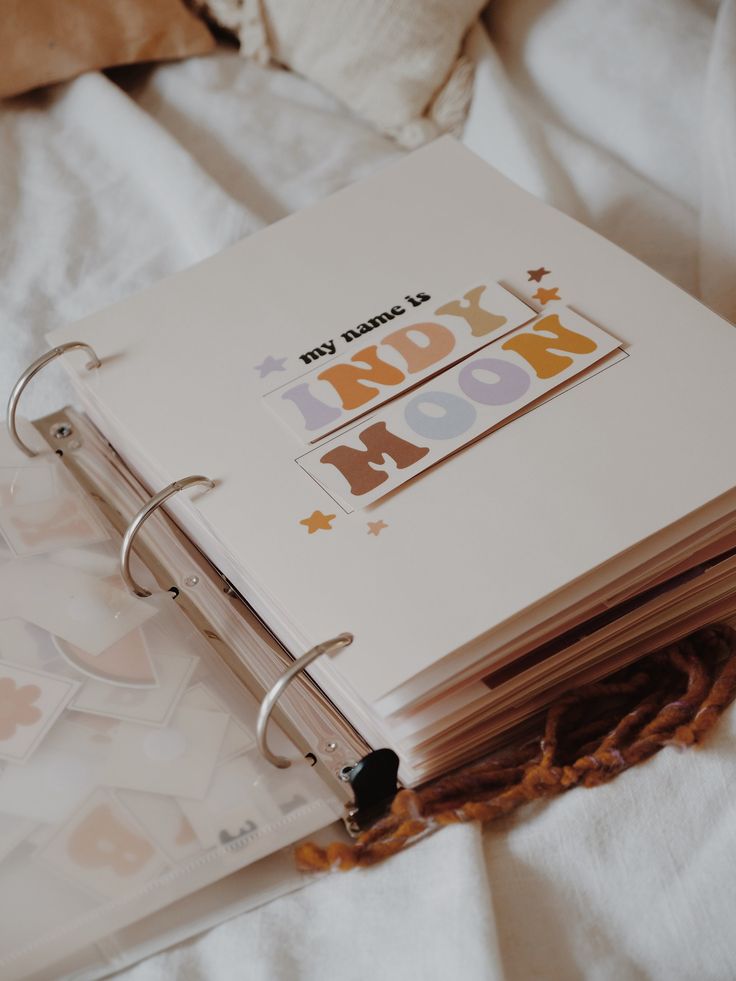 an open notebook sitting on top of a bed