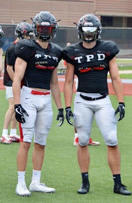 three football players are standing on the field