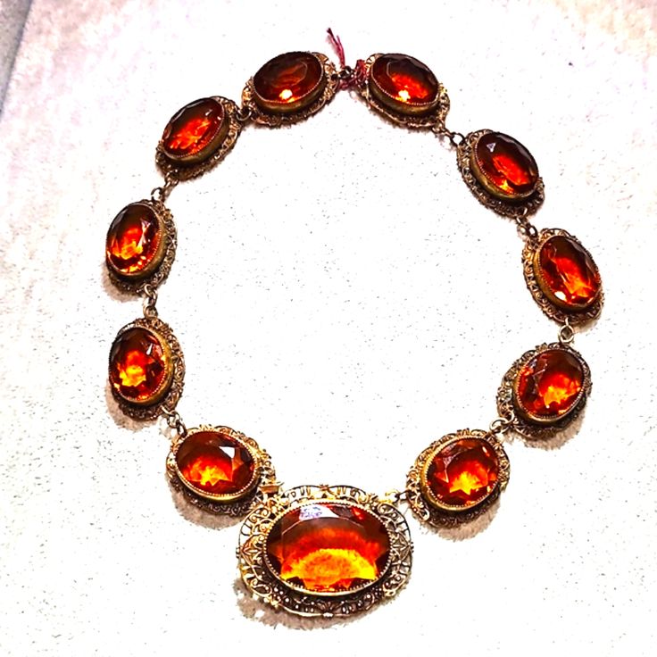 Gorgeous Antique Victorian Ornate Necklace With Amber Colored Glass Stones It Clips Onto The Front Larger Stone As Soon In Pictures. In Excellent Condition 16" No Chips Or Cracks. Luxury Amber Jewelry For Formal Occasions, Formal Round Cabochon Necklaces, Elegant Yellow Gold Glass Jewelry, Formal Cabochon Pendant Necklace, Luxury Jeweled Necklaces For Formal Occasions, Luxury Jeweled Necklace For Formal Occasions, Elegant Evening Cabochon Necklaces, Luxury Amber Oval Necklace, Antique Jeweled Jewelry For Formal Occasions