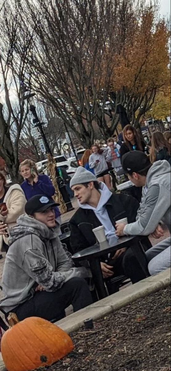 a group of people sitting on top of benches next to each other