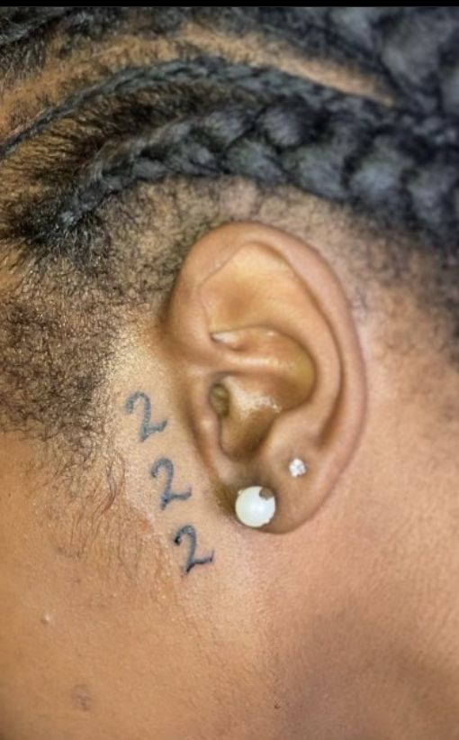 a close up of a person's ear with writing on it