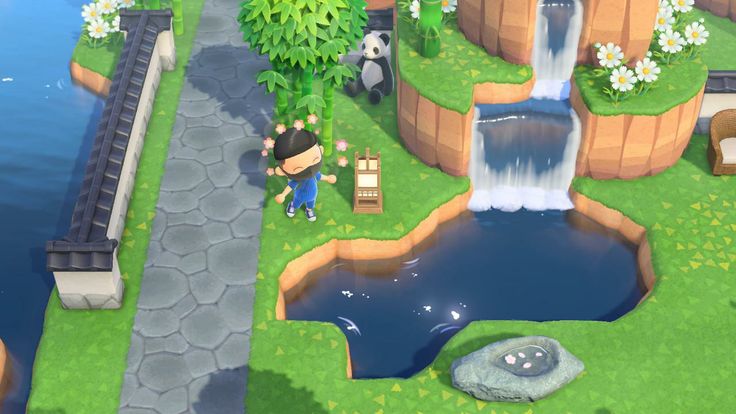 an animal crossing a bridge over a river in the middle of a lush green field