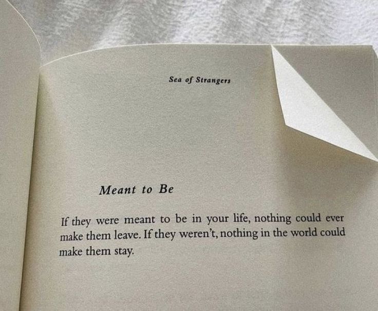 an open book with a piece of paper sticking out of it's center and the words meant to be