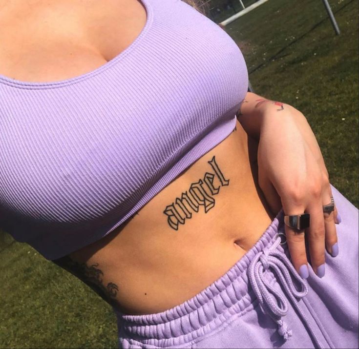 a woman with a tattoo on her stomach and the word hope written in cursive font