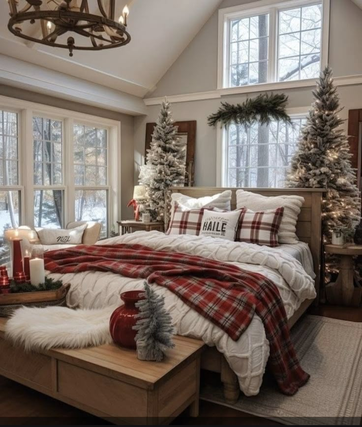 a bedroom decorated for christmas with white and red decorations on the windowsills, plaid bedding, and pillows