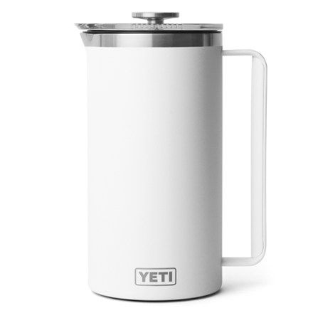 the yeti coffee mug is white and has a stainless steel lid