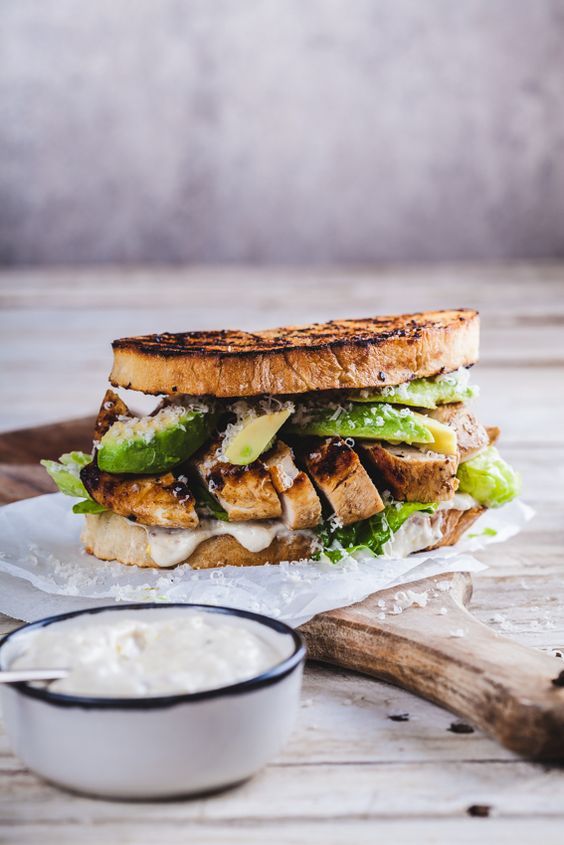 a grilled sandwich with lettuce, cucumber and mayonnaise