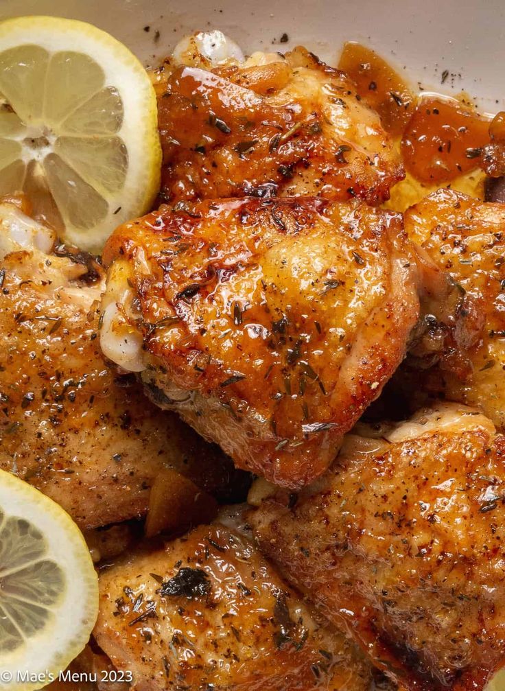 chicken with lemons and spices in a white bowl