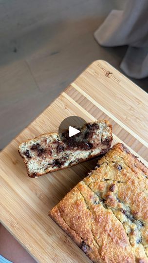 two pieces of bread sitting on top of a wooden cutting board