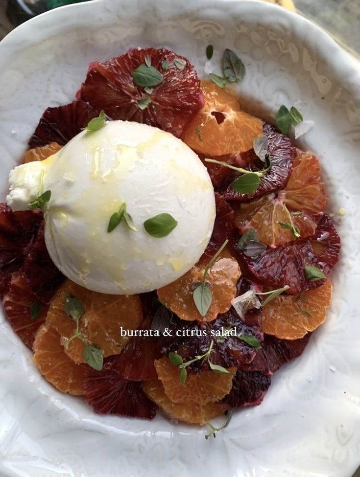 a white plate topped with oranges and ice cream