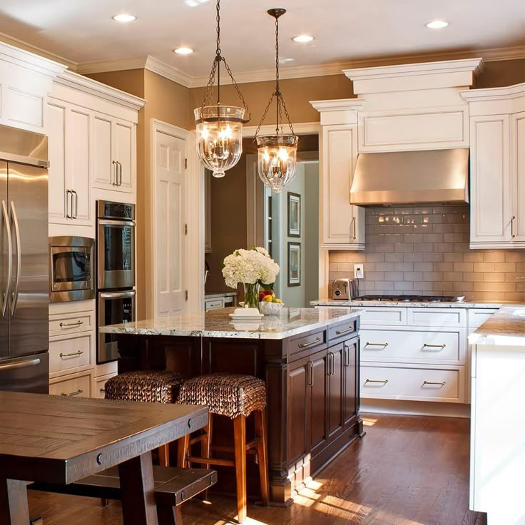 a kitchen with white cabinets and an island in front of the stove top oven is shown