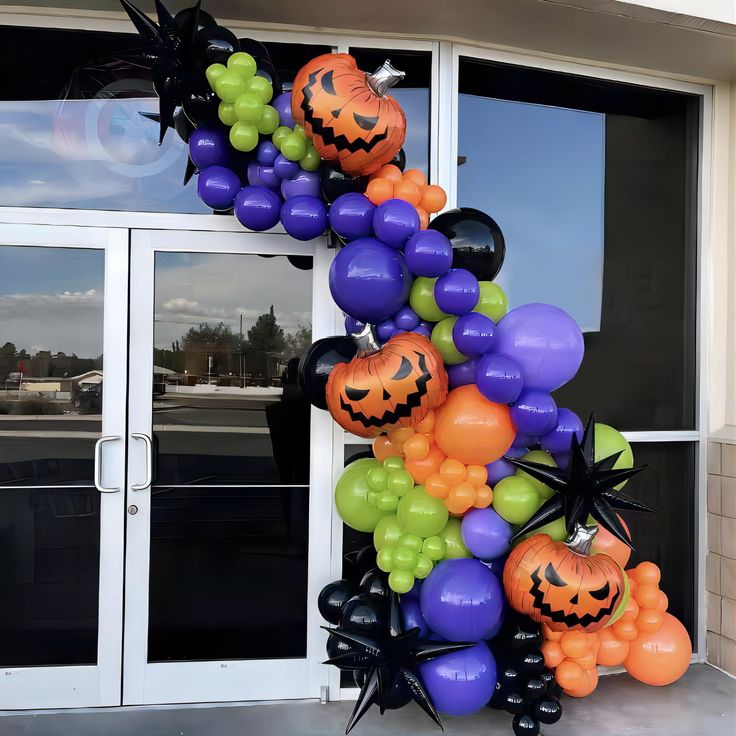 the balloon arch is decorated with halloween decorations