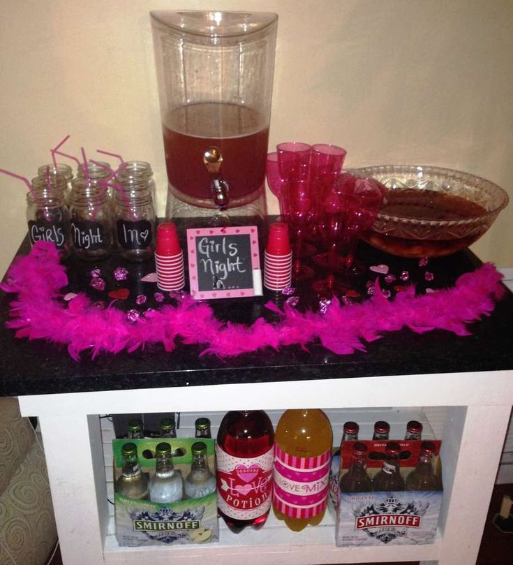 there is a shelf with bottles and glasses next to a drink dispenser