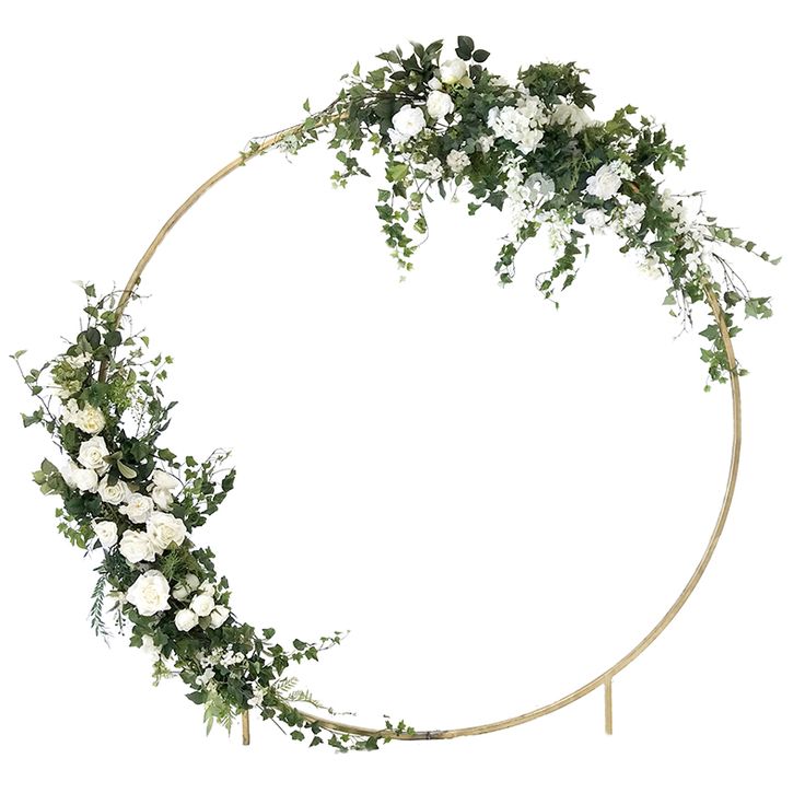 a circular wreath with white flowers and greenery