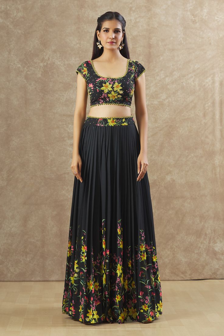 Black georgette lehenga with an attached cancan, floral print and sequins and beaded hand embroidered waistband. Comes with a padded blouse.
Components: 2
Pattern: Printed, Hand embroidered
Type Of Work: Floral, Sequins, Beads
Neckline: Round
Sleeve Type: Short
Fabric: Georgette
Color: Black
Other Details: 
Attached lining
Lehenga length : 45 inches
Approx Product Weight : 2 Kgs
Closure : Drawstrings
Occasion: Sangeet - Aza Fashions Georgette Lehenga, Round Pattern, Padded Blouse, Beaded Neckline, Pattern Blouse, Blouse Patterns, Set For Women, Aza Fashion, Sleeve Type