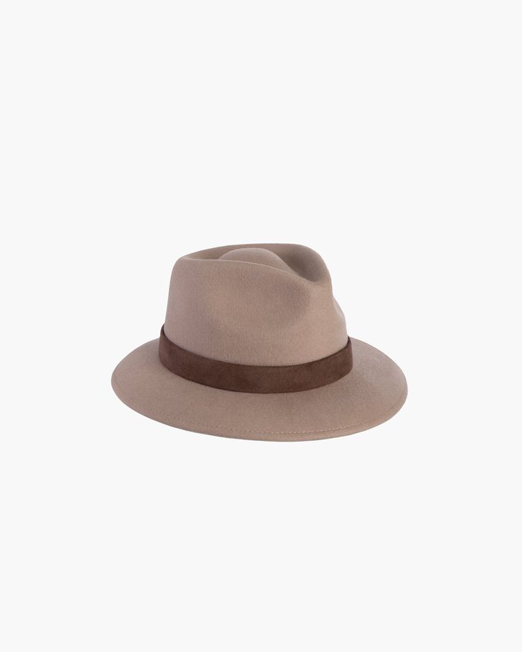 Versatile hand-blocked wool felt fedora banded with lamb leather is water-repellent. The Crown is fully lined. Elasticized inner band fits most. Packable. Made in the USA of imported materials. Sustainable wool is shorn and milled from multi-use sheep living on small farms under the most humane conditions. Designed and Handmade in NYC Hand blocked by skilled artisans Highest Quality Materials Sustainable wool Brim Span: 3" Wool Fedora, Felt Fedora, Hat Ideas, Fedora Hat, Fedora, Hats For Women, Wool Felt, Black And Brown, Fashion Shoes