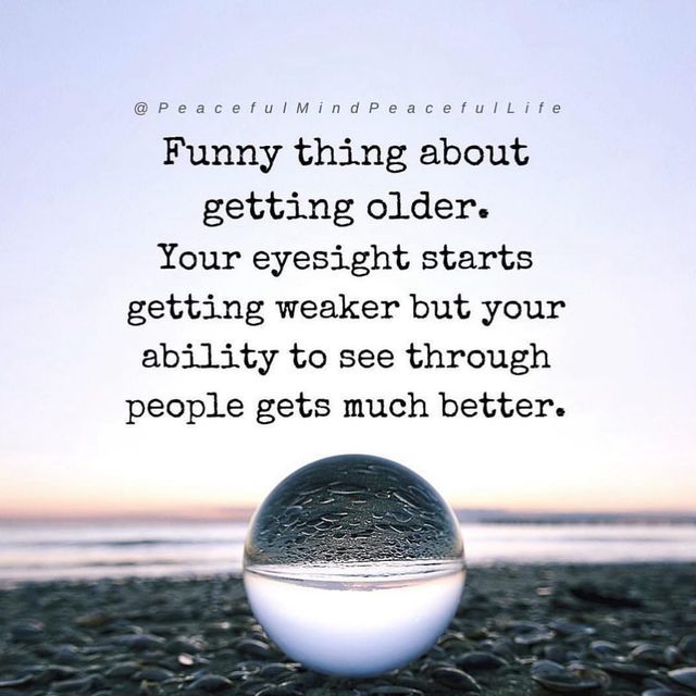 a glass ball sitting on top of a rocky beach next to the ocean with a quote about funny things about getting older