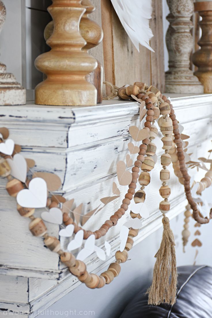 a mantle decorated with wooden hearts and tassels