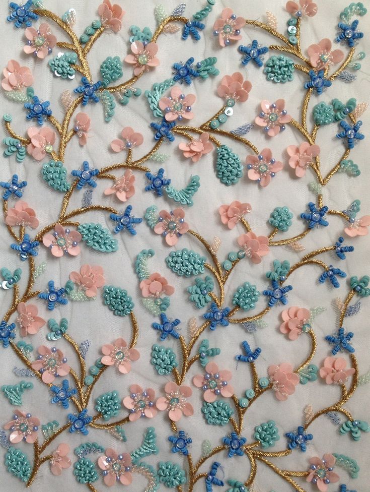 an embroidered fabric with flowers and leaves on it