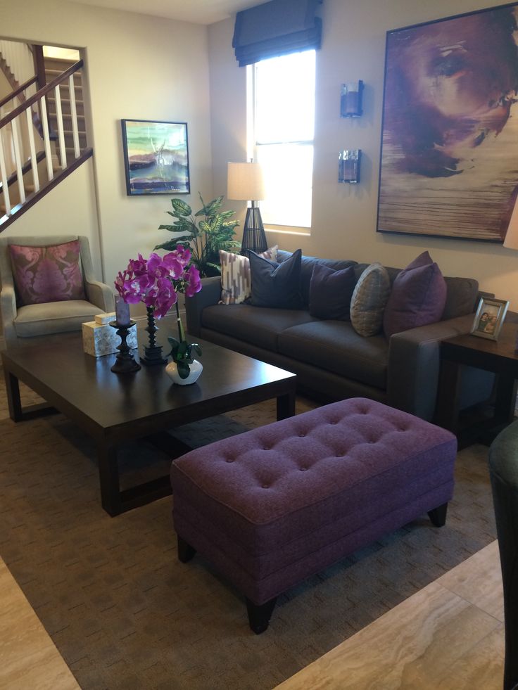 a living room filled with furniture and a stair case