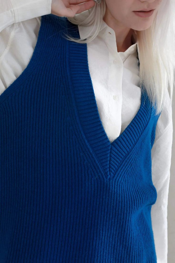 Make a Statement with our Deep V-Neck Wool Sweater Vest This Deep V-Neck Sweater Vest is your ultimate layering piece. Crafted from 100% wool, it offers a plush, cozy feel. With its deep plunge neckline and wide sleeve opening, it is designed for elegance and comfort. The tight stitching ensures it retains its structure, giving it a graceful drape. Style #: WSAH920 Sweater Vest Layering, Vest Layering, Tank Top Skirt, Casual Activewear, Classic Hats, Deep Plunge, Plunge Neckline, Shearling Coat, Cashmere Wool