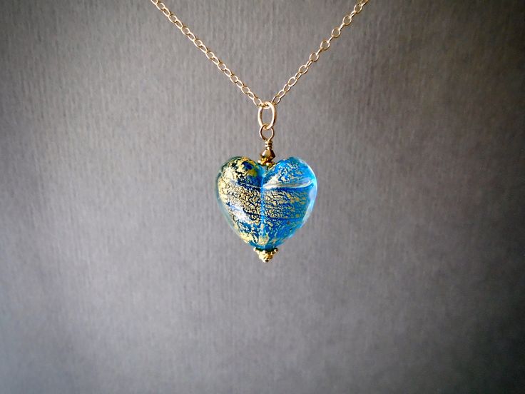 "⇩CLICK BELOW FOR DETAILS⇩ ✦This Venetian heart pendant has transparent aqua blue green Murano glass with 24k gold foil splashes, the glass and a bright blue exterior glass. A very classic look of authentic Murano Glass perfection! Also known as the crackle bead, it is made in the Ca' d'Oro fashion, a name originating from a villa on the Grand Canal. ✦The heart bead measures 17mm in length and width, and 1/2 inch in thickness for a puffy shape. It hangs from a 14k gold filled chain with spring c Blue Heart-shaped Keepsake Jewelry, Blue Heart Charm Jewelry As Gift, Blue Heart Charm Jewelry Gift, Blue Jewelry With Heart Charm For Gifting, Blue Heart Charm Jewelry As A Gift, Blue Heart Pendant Keepsake Jewelry, Blue Heart Charm Jewelry For Gift, Murano Glass Round Jewelry For Gift, Nickel-free Murano Glass Jewelry For Gifts