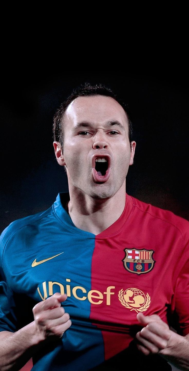 a soccer player with his mouth open and tongue out