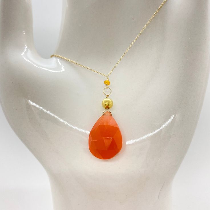 "Wire, Chain & Clasp: 14k Gold Stones: Carnelian Drop (approx. 18mm), Carnelian Bead (approx. 1mm x 2mm), 18k Gold Nugget (approx. 4mm) Necklace Length: approx. 17\" Backdrop: Freshwater Pearl & Tsavorite Backdrop Length: 1.75\" ------------------------------------------------------------ Let me know if you have any questions! *Size adjustable at client's request" Gold Faceted Chalcedony Jewelry, Orange Gemstone Drop Jewelry, Orange Drop Gemstone Jewelry, Elegant Faceted Carnelian Necklace, Elegant Orange Necklace For Healing, Elegant Orange Crystal Necklaces With Gemstone Beads, Orange Faceted Beads Jewelry For Gift, Faceted Carnelian Jewelry Gift, Handmade Orange Drop Jewelry