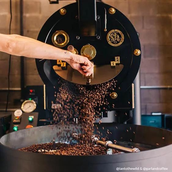 a person pouring coffee into a large pot