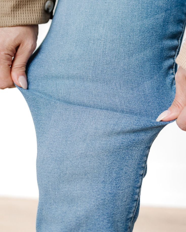 These jeans are high-waisted, bootcut style with a medium-wash blue denim. The denim has a subtle faded effect along the thighs and knees, giving them a slightly worn-in look. They are fitted through the hips and thighs, then gently flare out below the knee, providing a flattering silhouette. The back pockets have a classic, simple design without any embellishments or stitching details, maintaining a clean, streamlined appearance. The overall style has a retro-inspired, classic vibe, ideal for pairing with casual or semi-dressy outfits. Stretch Medium Wash Cropped Leg Flare Jeans, Medium Wash Stretch Flare Jeans With Cropped Leg, Faded Stretch Denim Jeans, Stretch Washed Blue Jeans With Frayed Hem, Stretch Washed Denim Jeans, Denim Blue Washed Stretch Flare Jeans, Stretch Washed Denim Flare Jeans, Stretch Denim Flare Jeans With Frayed Hem, Stretch Washed Denim Blue Jeans