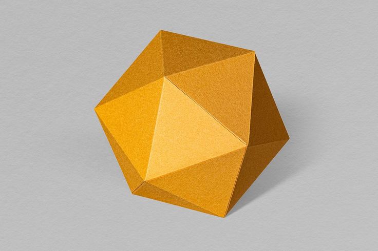 an orange origami object on a gray background