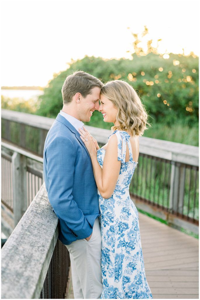 a man and woman standing next to each other on a bridge