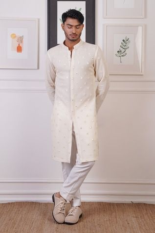 Cream straight kurta with scattered mirror embroidered buttis. Paired with a pant. - Aza Fashions Chanderi Bandhgala With Mirror Work And Long Sleeves, Long Sleeve Chanderi Bandhgala With Mirror Work, Navratri Long Sleeve Sherwani With Gota Work, Navratri Long Sleeve Sherwani With Mirror Work, Long Sleeve Sherwani With Mirror Work For Navratri, Navratri Sherwani With Gota Work And Long Sleeves, Designer Cotton Silk Sherwani With Mirror Work, Eid Chanderi Bandhgala With Mirror Work, Eid Bandhgala With Mirror Work In Chanderi Fabric