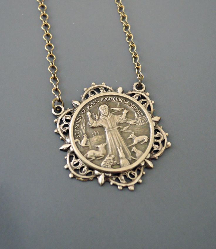 "Vintage Jewelry - Vintage Necklace - Saint Francis necklace - Brass Necklace - Religious jewelry - Catholic necklace - handmade jewelry This is such a beautiful vintage necklace. Vintage brass highly detailed image of St. Francis surrounded by animals. Exquisite detail with a rich patina. The solid brass pendant hangs from a beautiful vintage ladder chain. Chloe says, Wear it and feel fabulous!\" The pendant is 1 1/2\" long. You can choose the necklace length you would like at checkout. Thanks Victorian Antique Silver Nickel-free Necklace, Handmade Vintage Antique Silver Jewelry, Handmade Vintage Jewelry In Antique Silver, Antique Personalized Jewelry Collectible, Antique Finish Medallion Necklace Gift, Antique Finish Medallion Necklace As Gift, Vintage Personalized Jewelry For Collectors, Handmade Vintage Jewelry With Round Pendant, Nickel Free Antique Silver Necklace For Anniversary